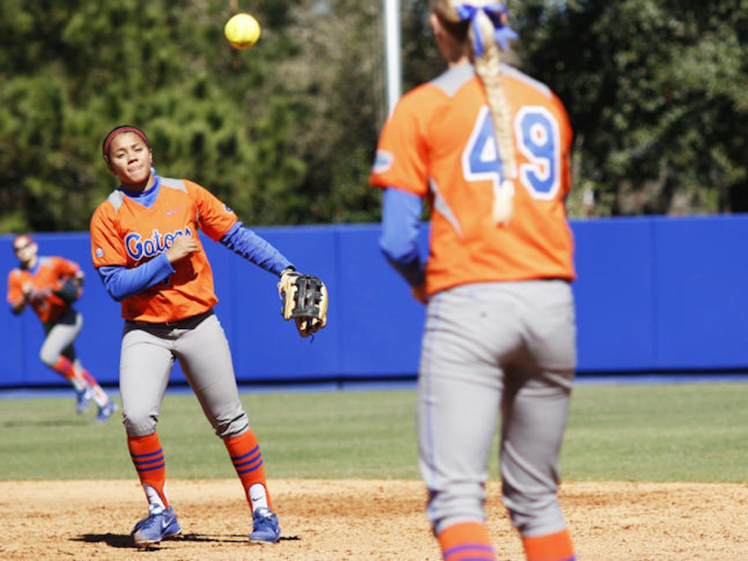 Freshman infielder Kelsey Stewart (7) throws a ball to freshman first baseman Taylor Schwarz (49) to end an inning during Florida’s 9-1 win over UNC Wilmington on Feb. 17 at Katie Seashole Pressly Stadium. Stewart is one of Florida's key underclassmen who have fueled the team's success this season.&nbsp;