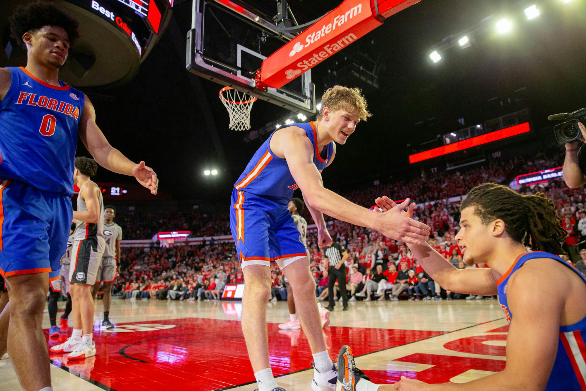 Gators men's basketball freshman forward Thomas Haugh goes to help up guard Walter Clayton Jr. in the team's win over the Georgia Bulldogs on Saturday, February 18, 2024.