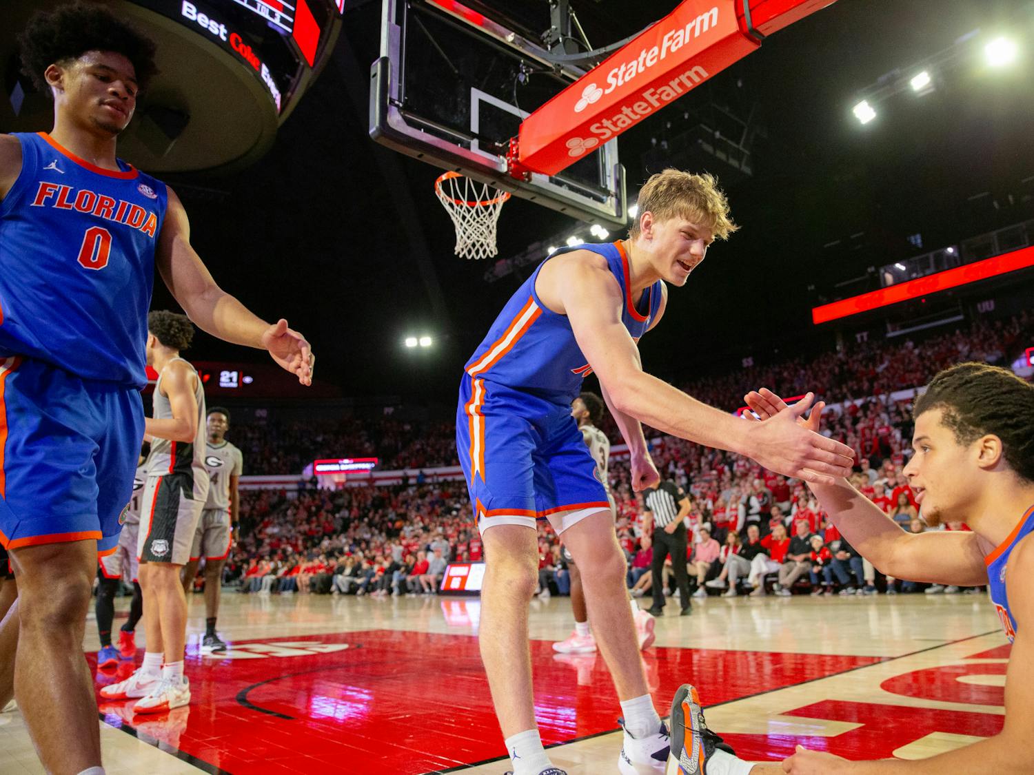 Gators men's basketball freshman forward Thomas Haugh goes to help up guard Walter Clayton Jr. in the team's win over the Georgia Bulldogs on Saturday, February 18, 2024.