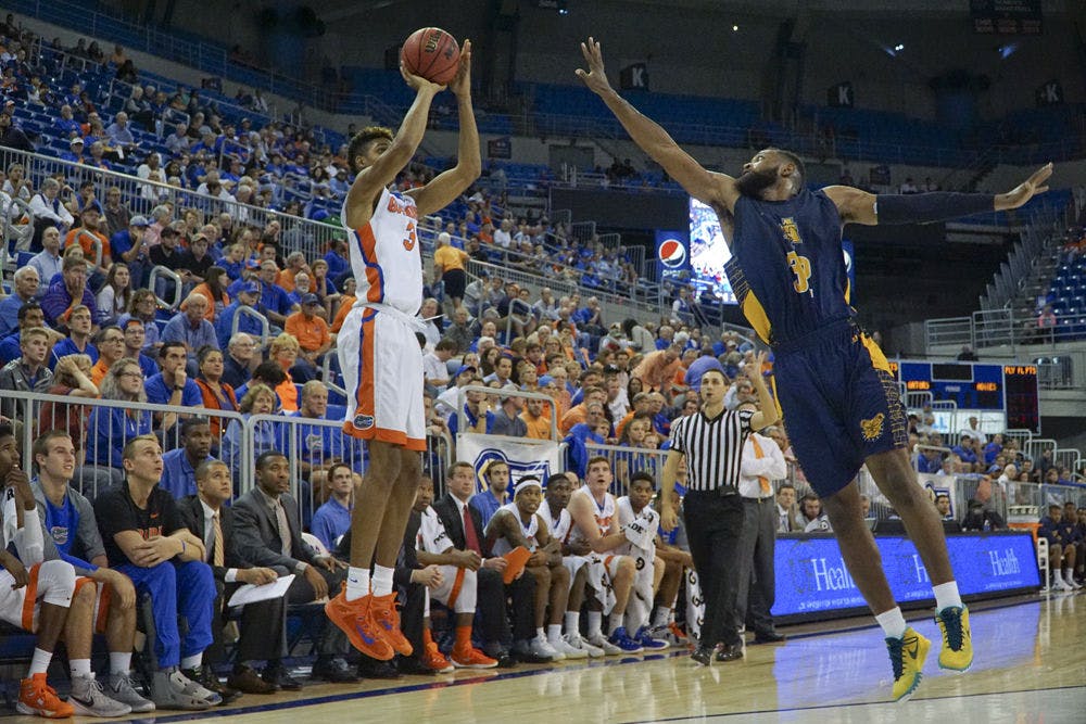 <p>UF forward Devin Robinson shoots a three-pointer during the second half of Florida's 104-54 win against North Carolina A&amp;T on Nov. 16, 2015, in the O'Connell Center.</p>