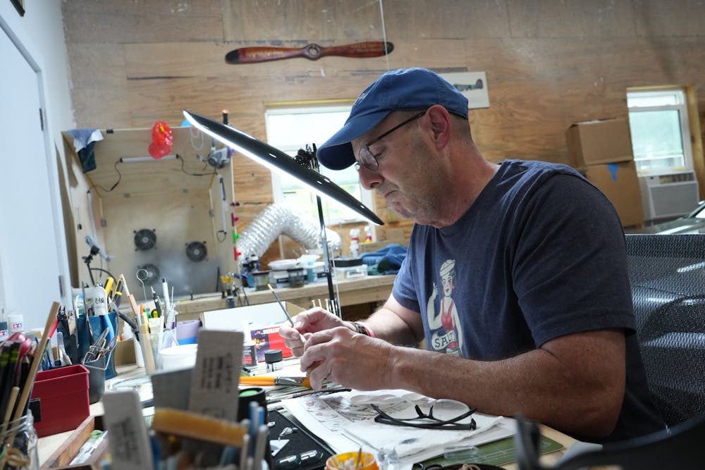 Sam Harris, former navy pilot and UF alumni, works on a model B-17 flying fortress at his home in Ormond Beach on Wednesday, June 14, 2023. 