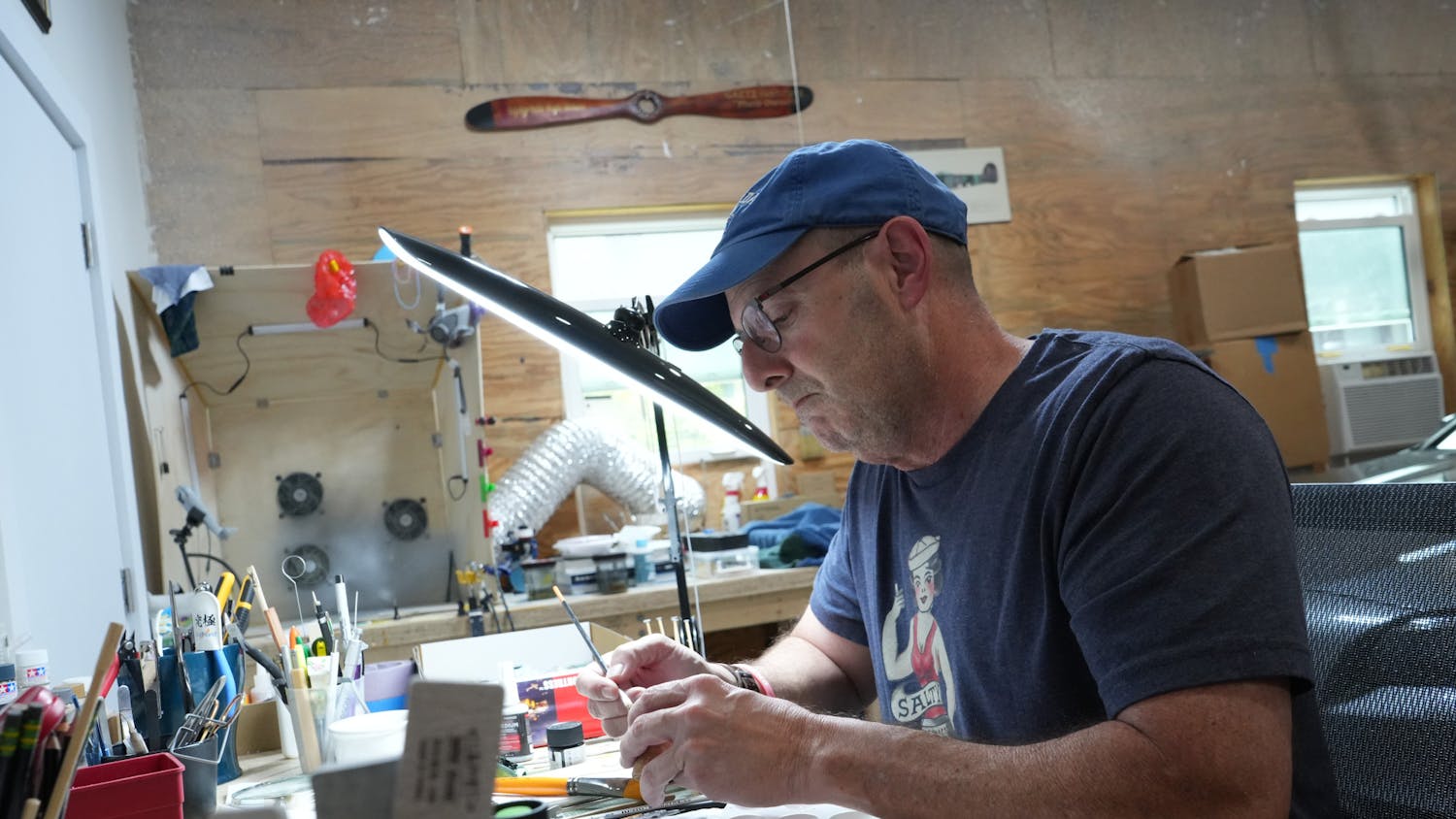 Sam Harris, former navy pilot and UF alumni, works on a model B-17 flying fortress at his home in Ormond Beach on Wednesday, June 14, 2023. 