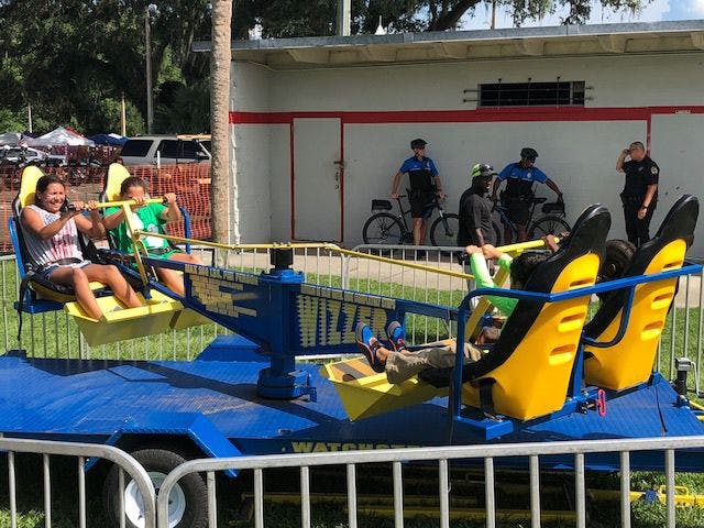 Children board the Wizzer, one of many outdoor attractions featured at the festival.
