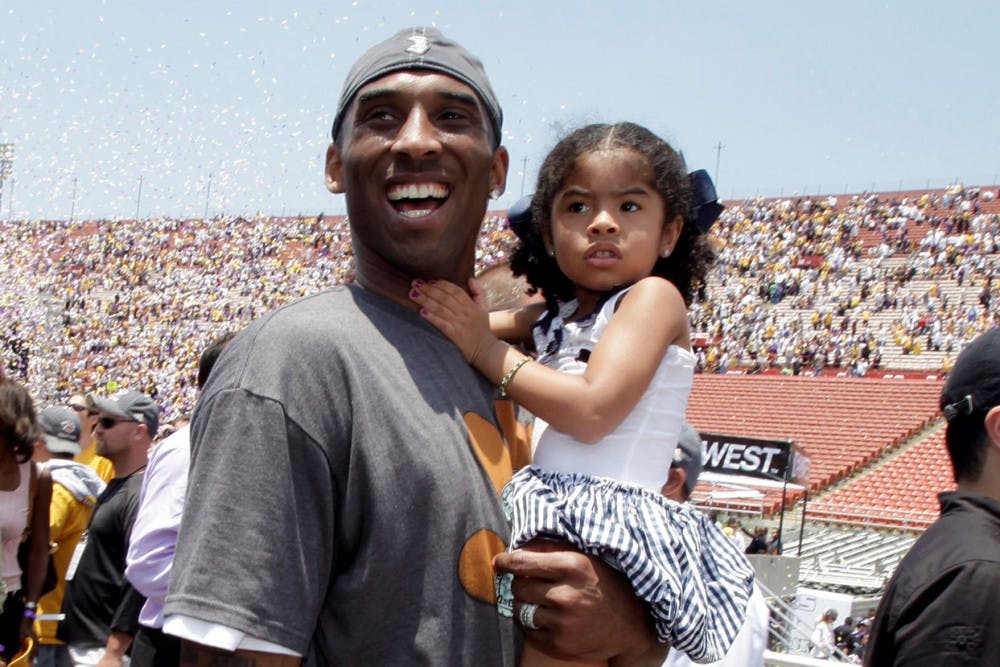 In this June 17, 2009 file photo Los Angeles Lakers' Kobe Bryant smiles as he and his daughter Gianna Maria-Onore walk up the steps after the victory parade celebrating the Lakers' NBA championship in Los Angeles. Bryant, the 18-time NBA All-Star who won five championships and became one of the greatest basketball players of his generation during a 20-year career with the Los Angeles Lakers, died in a helicopter crash Sunday, Jan. 26, 2020. Gianna also died in the crash. (AP Photo/Jae C. Hong, file)