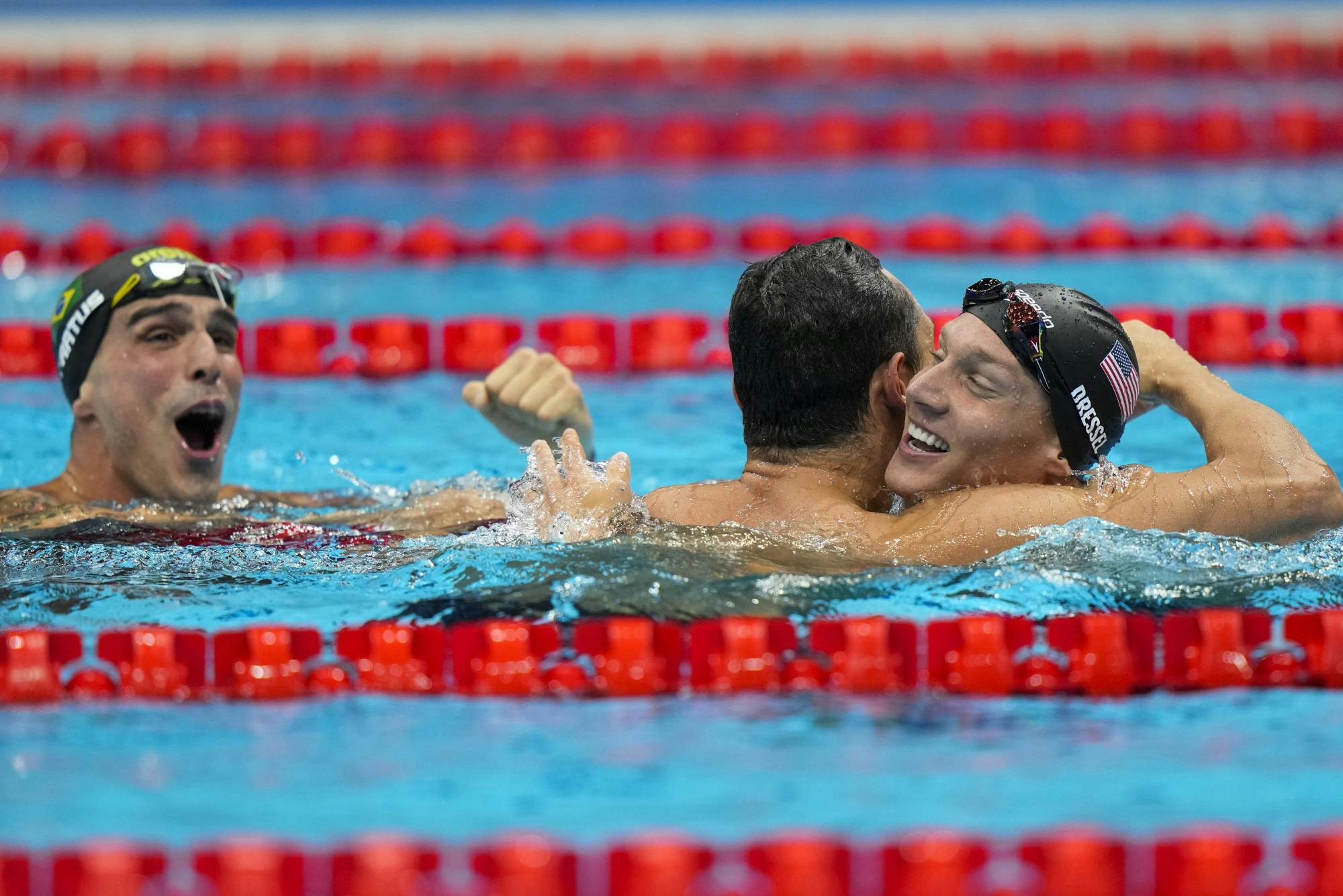 Caeleb Dressel, of United States, celebrates after winning the gold medal in a men's 50-meter freestyle fiat the 2020 Summer Olympics, Sunday, Aug. 1, 2021, in Tokyo, Japan. At left Bruno Fratus, of Brazil, celebrates winning the bronze medal. (AP Photo/David Goldman)