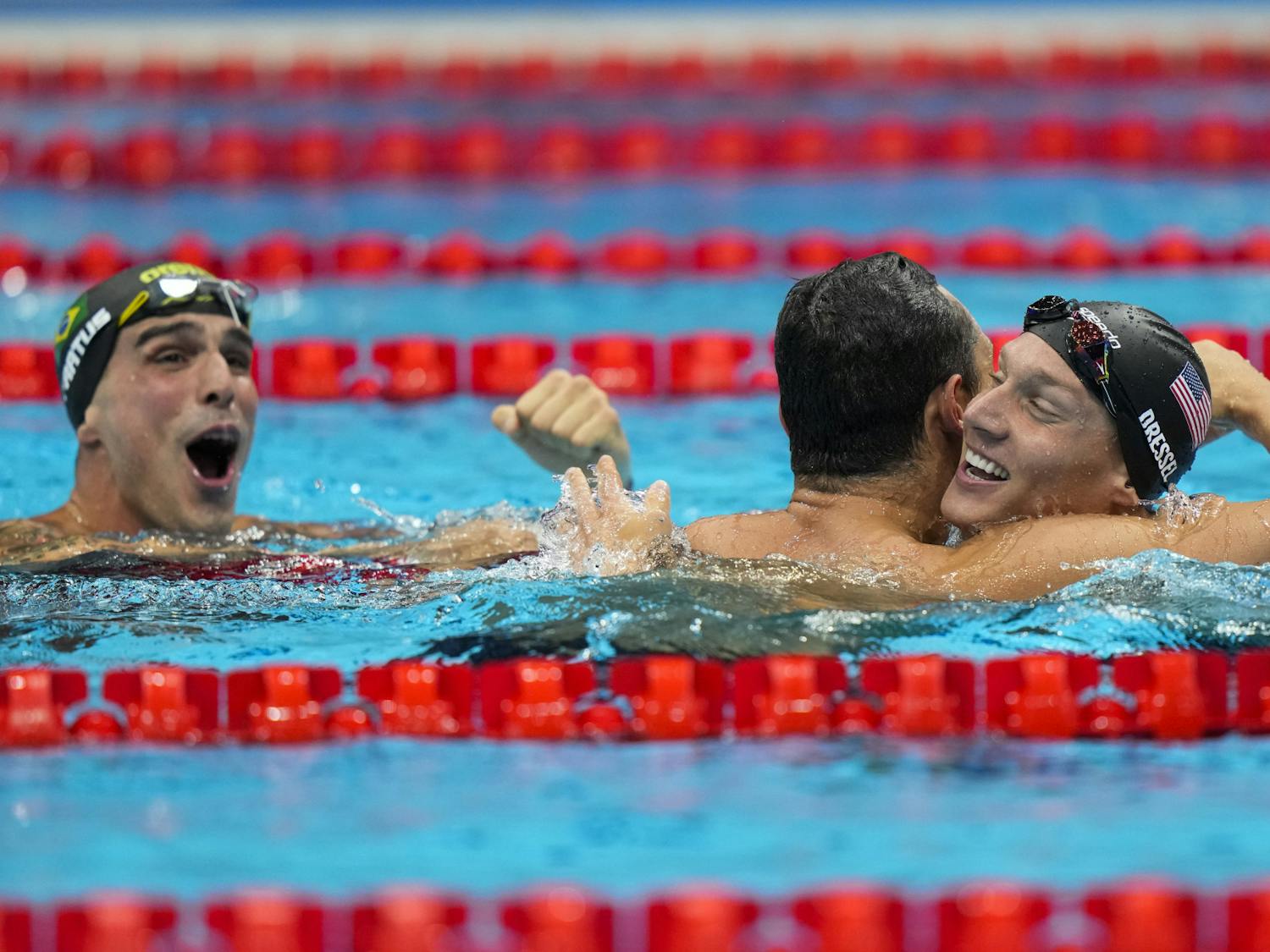 Caeleb Dressel, of United States, celebrates after winning the gold medal in a men's 50-meter freestyle fiat the 2020 Summer Olympics, Sunday, Aug. 1, 2021, in Tokyo, Japan. At left Bruno Fratus, of Brazil, celebrates winning the bronze medal. (AP Photo/David Goldman)
