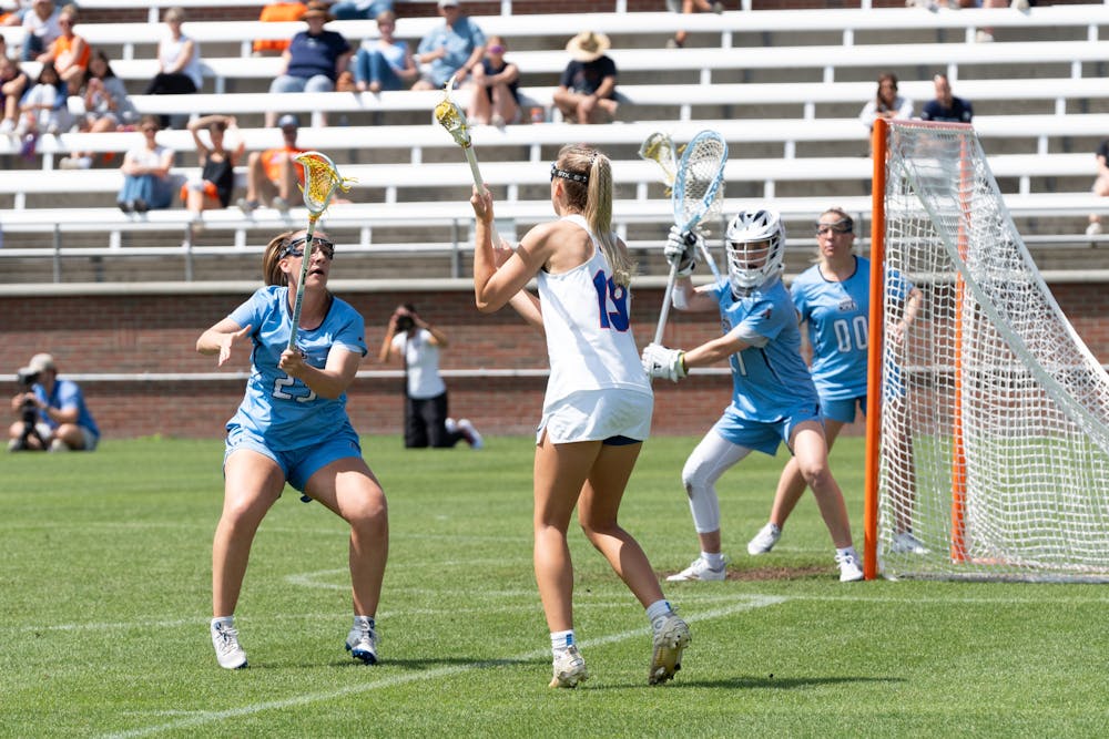 Florida lacrosse senior attack Maggi Hall meets two defenders at the goal during their game against Old Dominion on Saturday, March 23, 2024. 