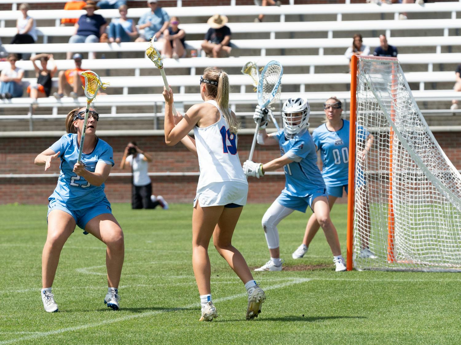 Florida lacrosse senior attack Maggi Hall meets two defenders at the goal during their game against Old Dominion on Saturday, March 23, 2024.