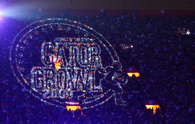 A Gator Growl light projection shines over the crowd during a previous homecoming celebration. The event, known as "the largest student-run pep rally in the world," will have fireworks this year.