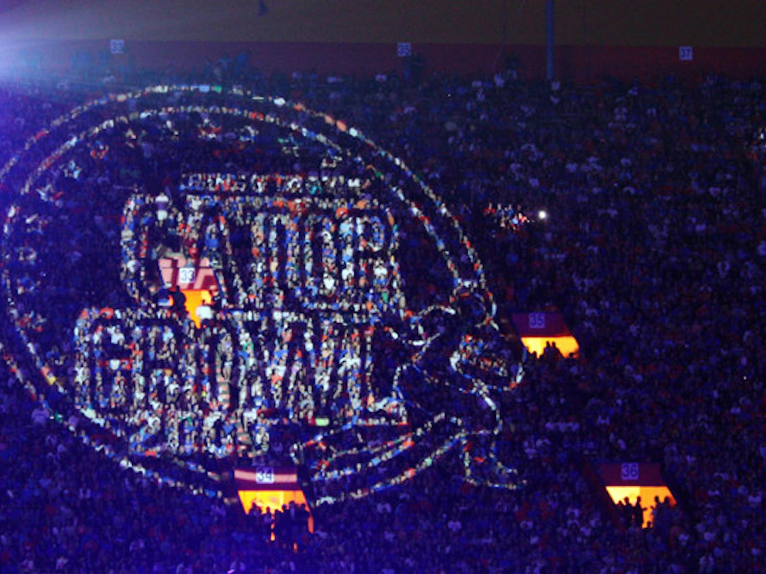 A Gator Growl light projection shines over the crowd during a previous homecoming celebration. The event, known as "the largest student-run pep rally in the world," will have fireworks this year.
