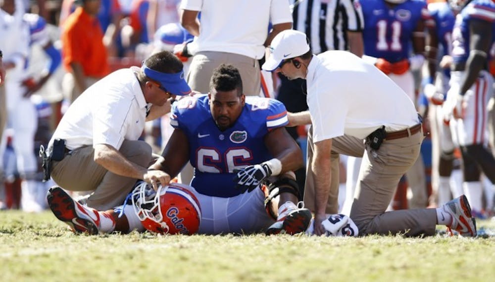 <p>Offensive lineman James Wilson gets helped off the field Saturday at Ben Hill Griffin Stadium. Florida beat Missouri 14-7.</p>