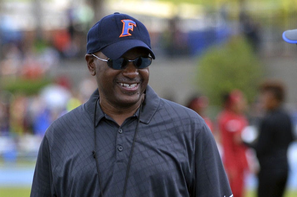 <p>UF coach Mike Holloway smiles during the 2015 Florida Relays at James G. Pressly Stadium.</p>