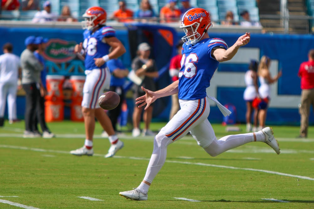 Punter Jeremy Crawshaw warms up before the Gators' game against the Georgia Bulldogs on Saturday, Oct. 28, 2023.