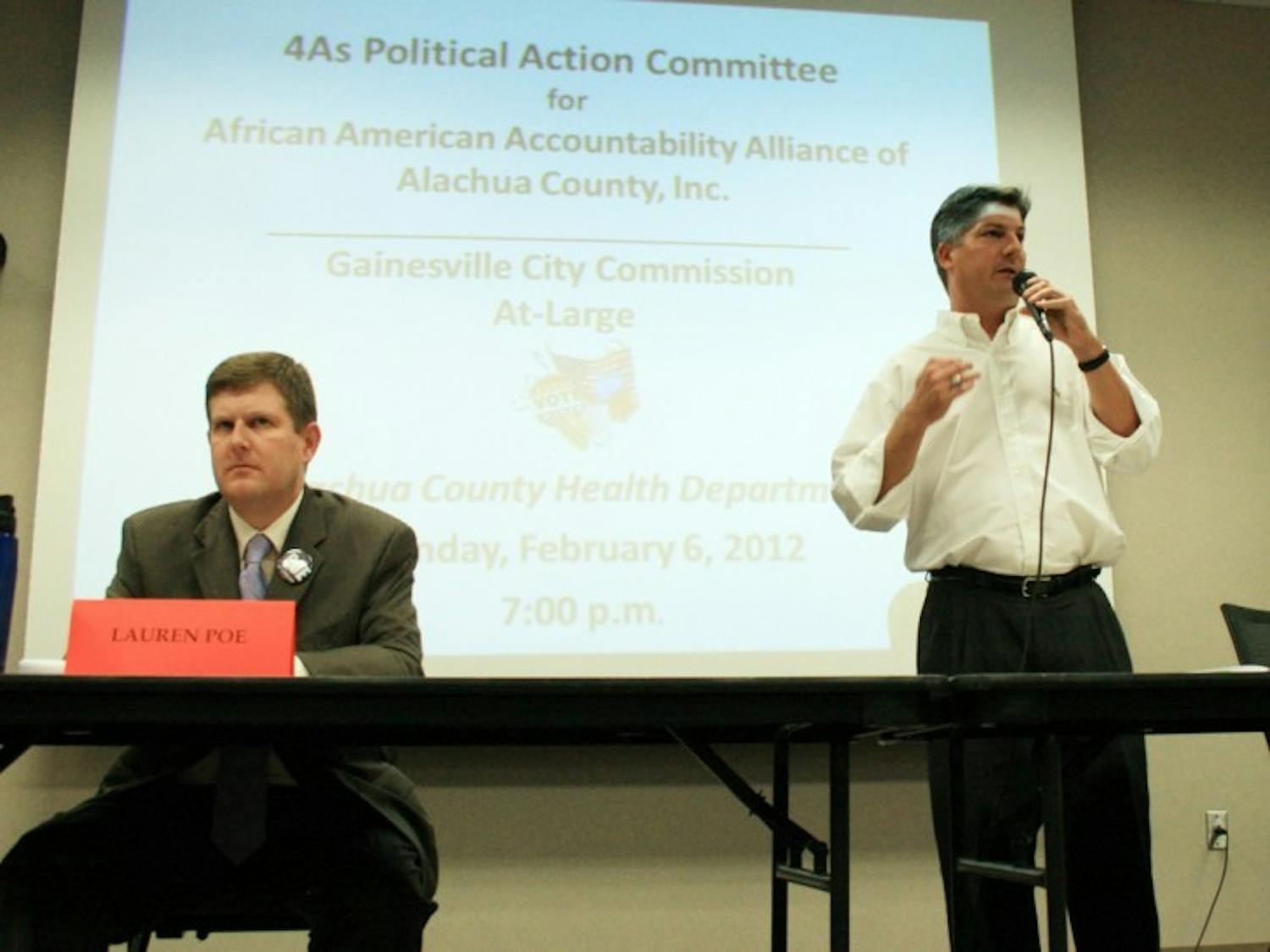 Lauren Poe and Nathan Skop, Gainesville City Commission at-large 1 candidates, answer questions posed by the African American Accountability Alliance of Alachua County at the Alachua County Health Department on Monday night.