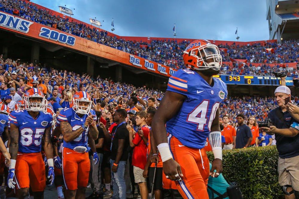 <p>Senior linebacker Jarrad Davis leads his team out of the tunnel before Florida's 32-0 win against North Texas on Sept. 17, 2016, at Ben Hill Griffin Stadium in Gainesville.&nbsp;</p>