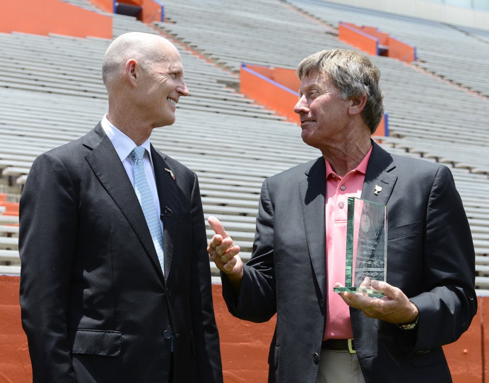 Gov. Rick Scott presents former Florida football coach Steve Spurrier with the Great Floridian Award on Thursday afternoon at Ben Hill Griffin Stadium. Spurrier is the 71st recipient of the honor since 1981. 