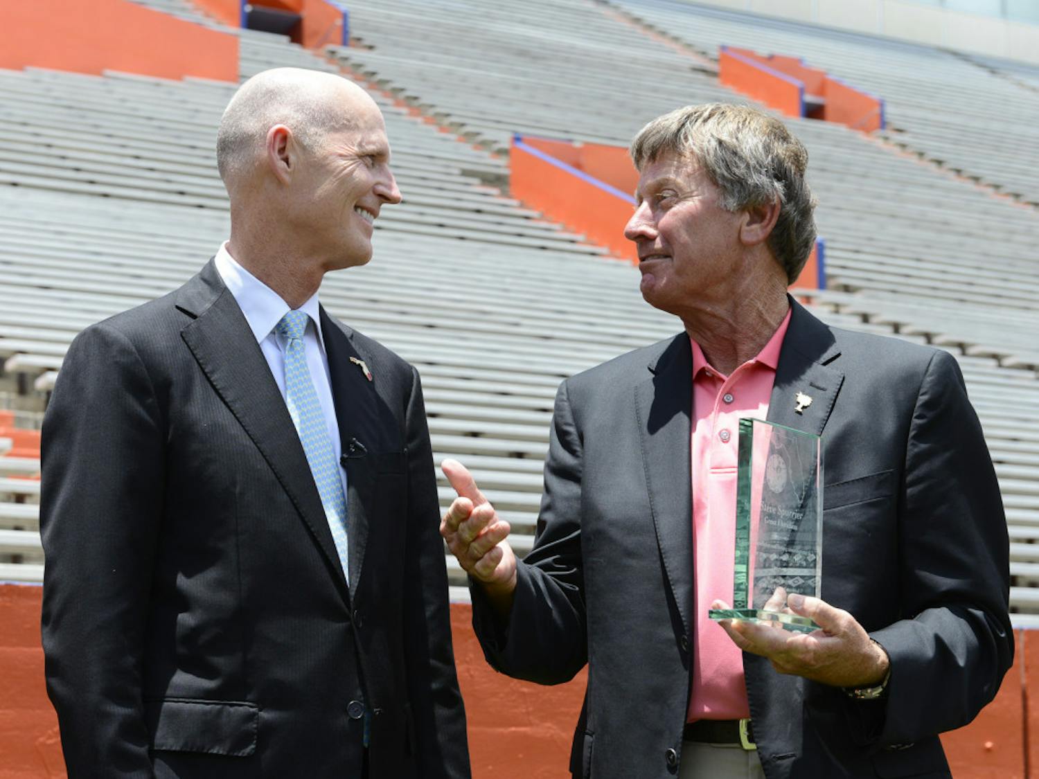 Gov. Rick Scott presents former Florida football coach Steve Spurrier with the Great Floridian Award on Thursday afternoon at Ben Hill Griffin Stadium. Spurrier is the 71st recipient of the honor since 1981.