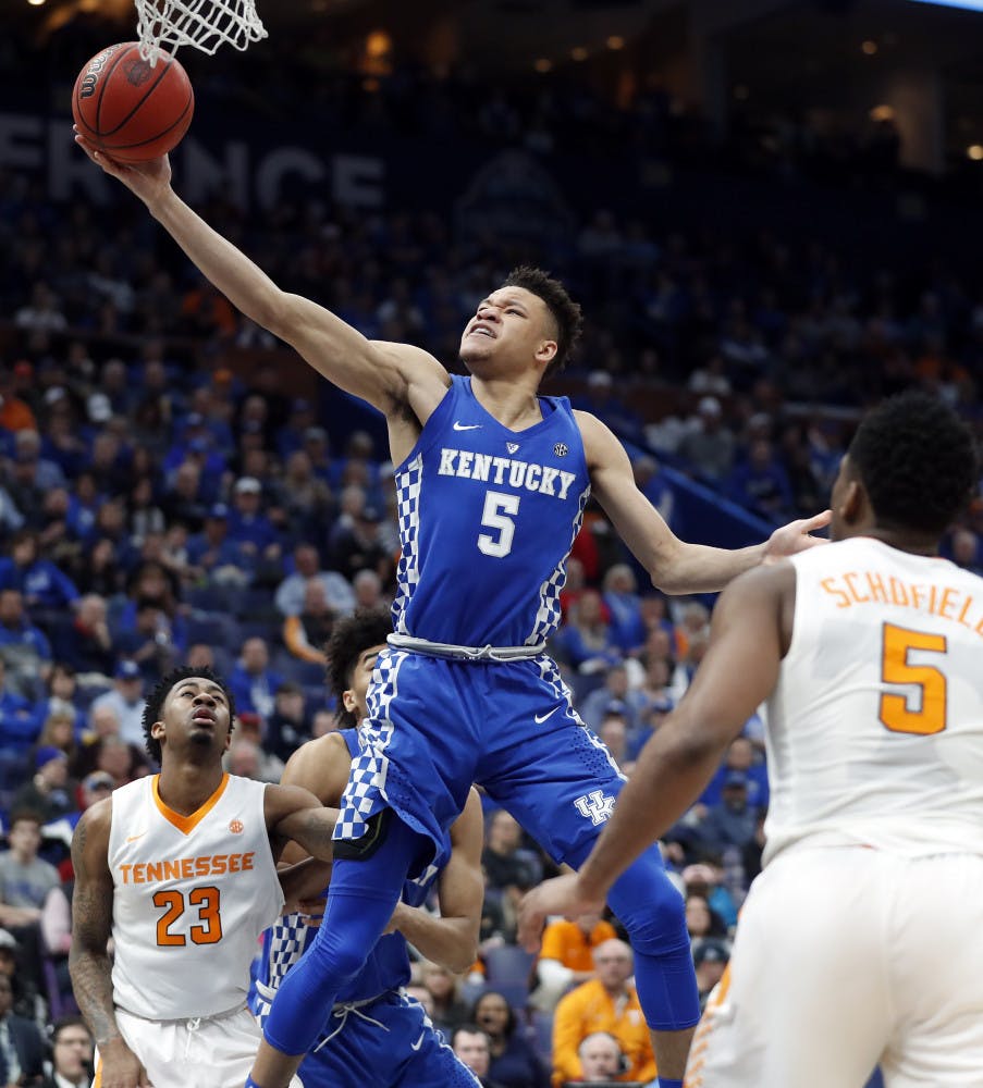 Kentucky's Kevin Knox, center, scores between Tennessee defenders Jordan Bowden (23) and Admiral Schofield, right, during the second half of an NCAA college basketball championship game at the Southeastern Conference tournament Sunday, March 11, 2018, in St. Louis. (AP Photo/Jeff Roberson)