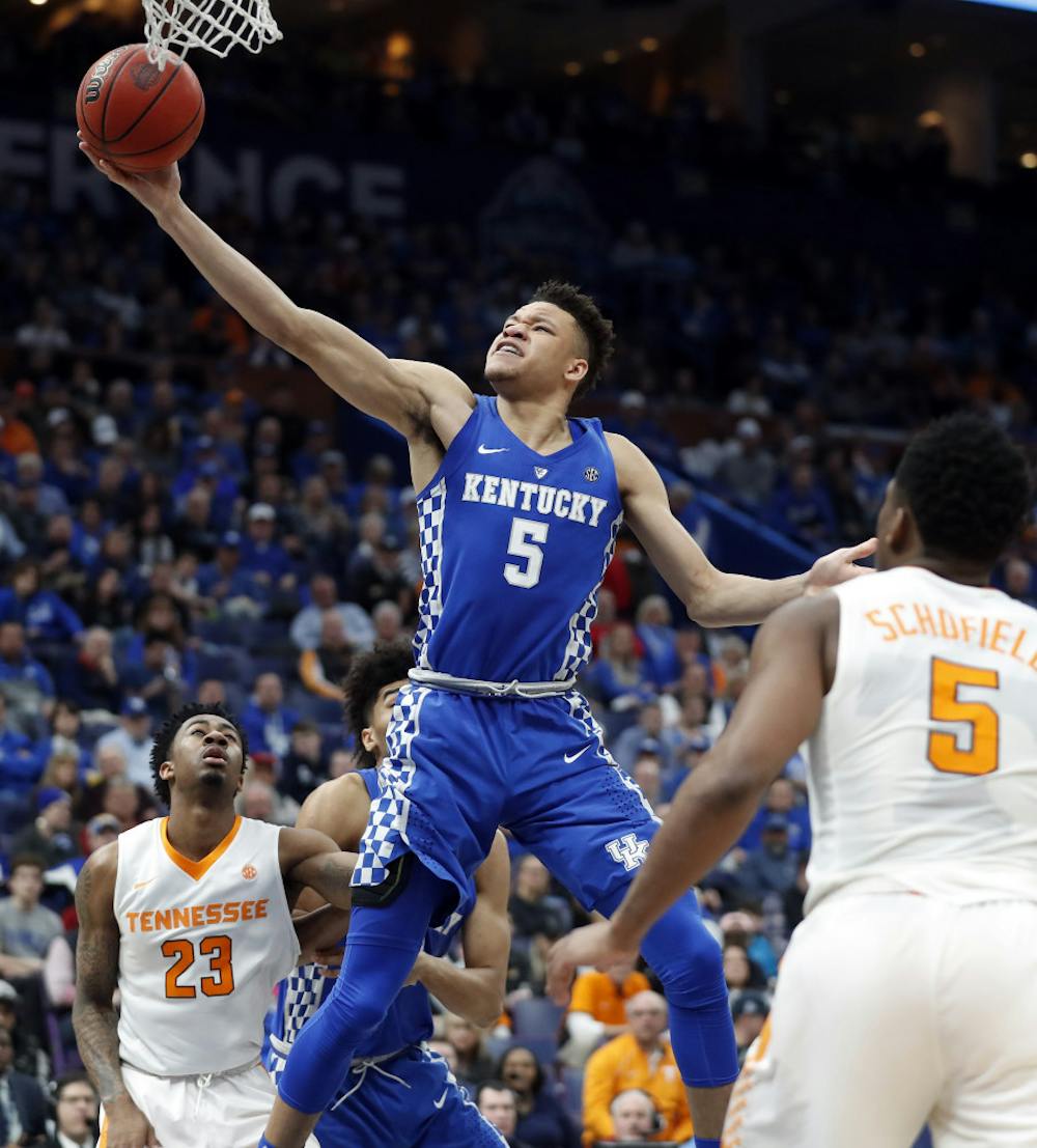 <p>Kentucky's Kevin Knox, center, scores between Tennessee defenders Jordan Bowden (23) and Admiral Schofield, right, during the second half of an NCAA college basketball championship game at the Southeastern Conference tournament Sunday, March 11, 2018, in St. Louis. (AP Photo/Jeff Roberson)</p>