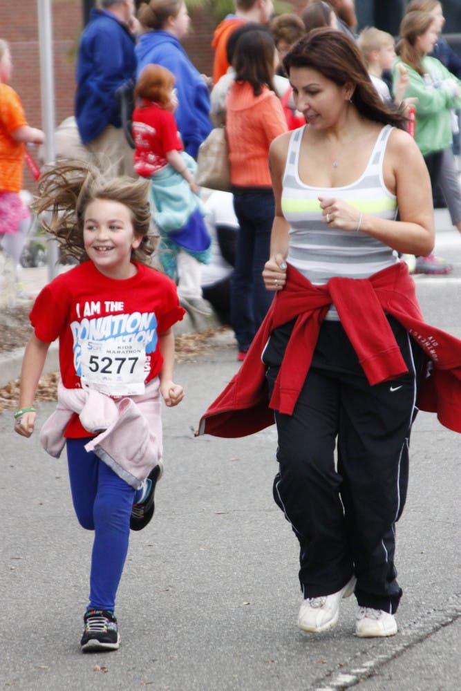Brenna Fox, 8, runs with her mother Yael Fox, 32, in the Five Points of Life Kids Marathon. This was their second year participating.