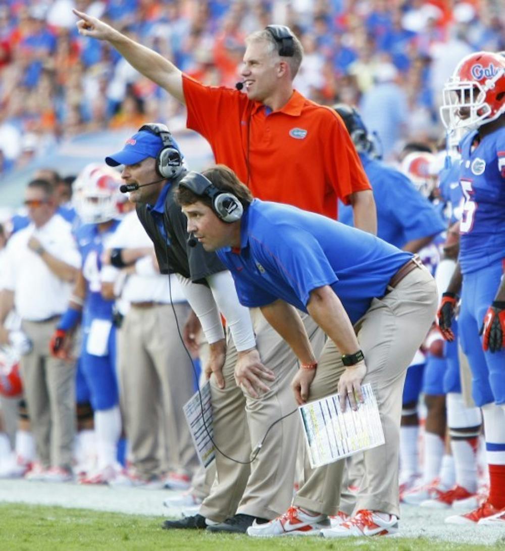 <p align="justify">Defensive coordinator Dan Quinn and coach Will Muschamp look on during UF’s 14-6 win against LSU on Oct. 6 in The Swamp. Quinn and Muschamp coached together in the NFL.</p>