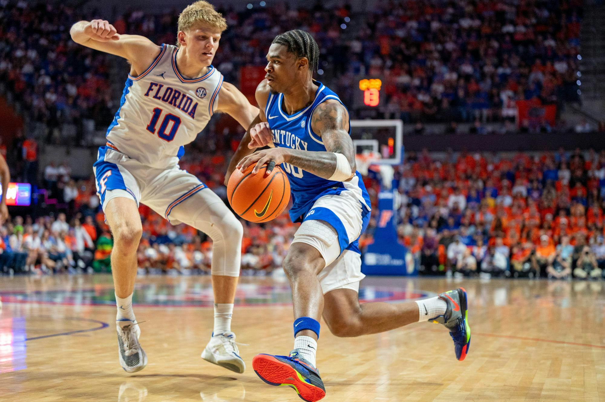 Kentucky guard Otega Oweh (00) dribbles against Florida forward Thomas Haugh (10) during the second half of an NCAA college basketball game, Saturday, Feb. 14, 2026 at Exactech Arena in Gainesville, Fla.
