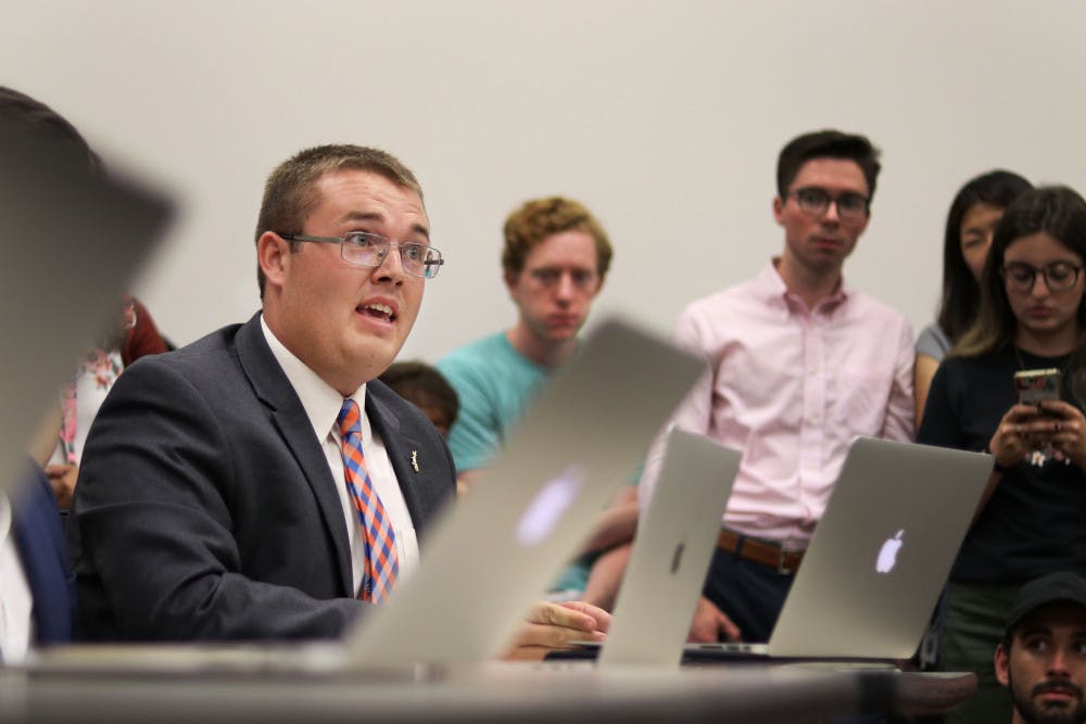 Branden Pearson speaks in defense of Gator Party against allegations of campaign violations Thursday evening at a Student Government Elections Commission meeting at the Levin College of Law. The meeting followed a contentious Senate race between Gator Party and Inspire Party. 