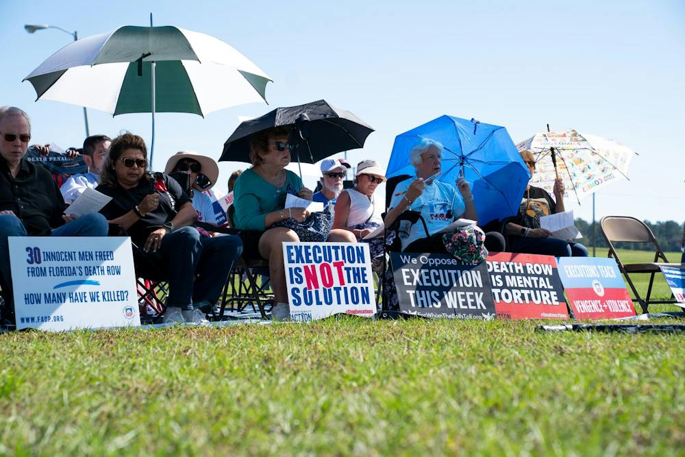 <p>Protestors sit outside the Florida State Prison, Tuesday, Oct. 13, 2026, in Raiford, Fla.</p>