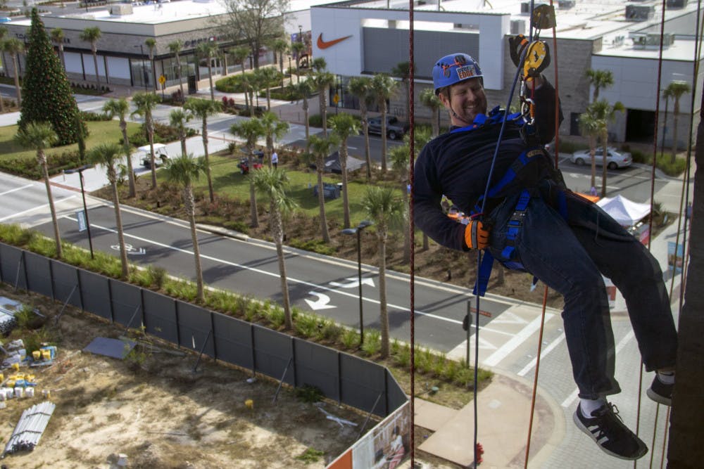 Gainesville Mayor Lauren Poe descends down the side of the 5001 building in Celebration Pointe Friday during the Alachua Habitat for Humanity’s Over the Edge fundraiser. The fundraiser raised at least  $15,000 for the organization. “You just lean back and enjoy the ride,” Poe said.