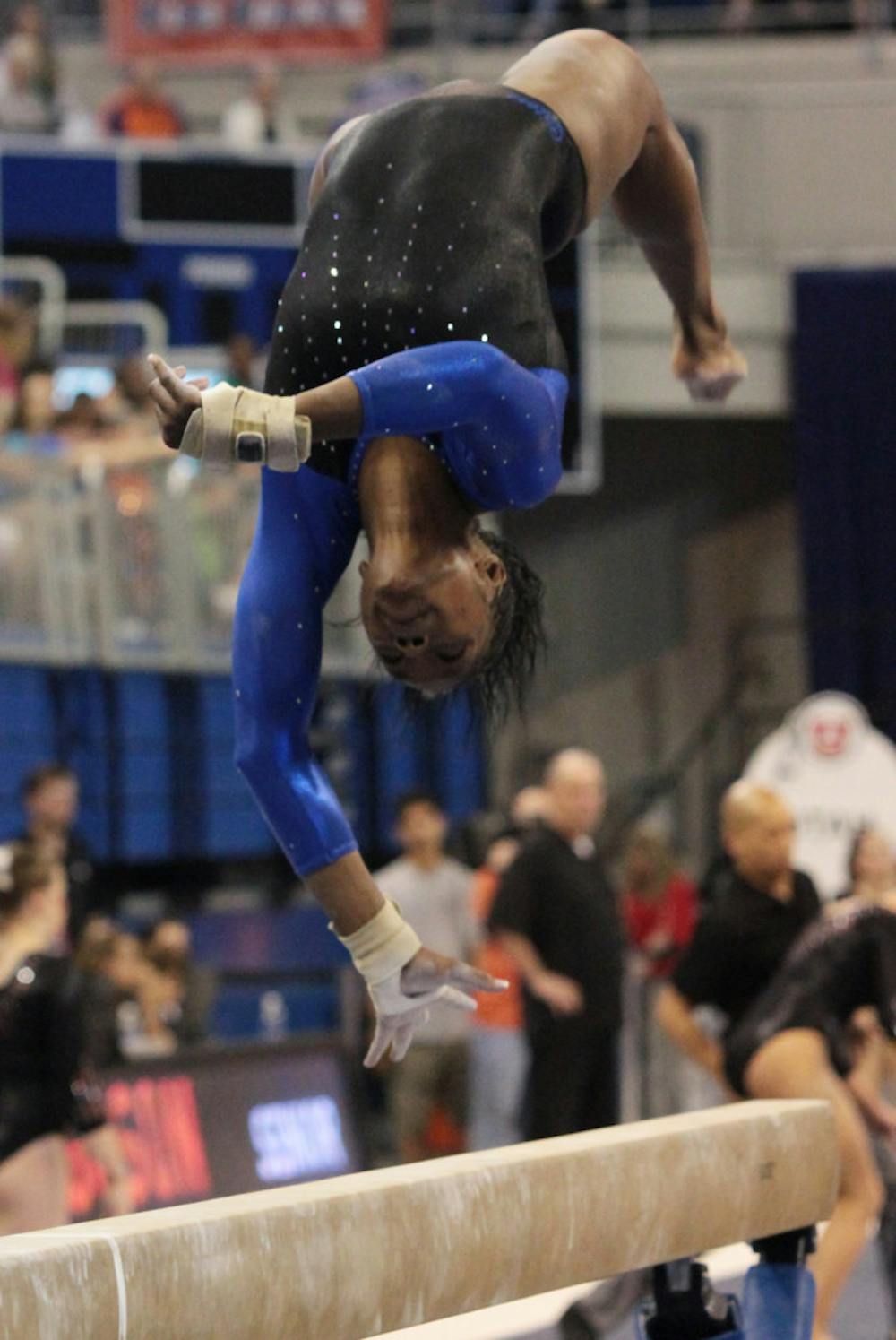 <p>Junior Ashanée Dickerson spots her landing during a beam routine. She is looking to be more consistent as UF heads to NCAA Regionals.</p>