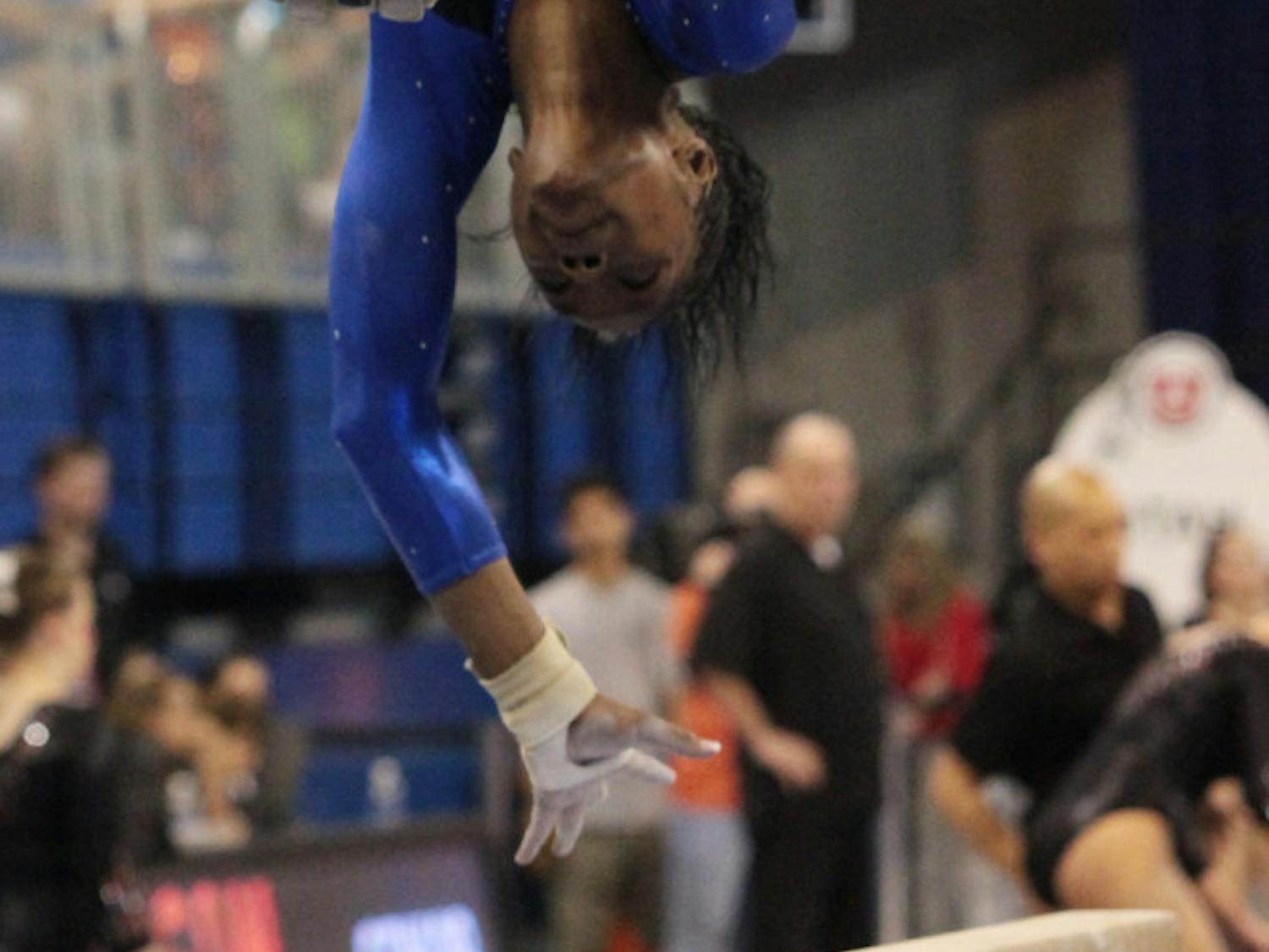 Junior Ashanée Dickerson spots her landing during a beam routine. She is looking to be more consistent as UF heads to NCAA Regionals.