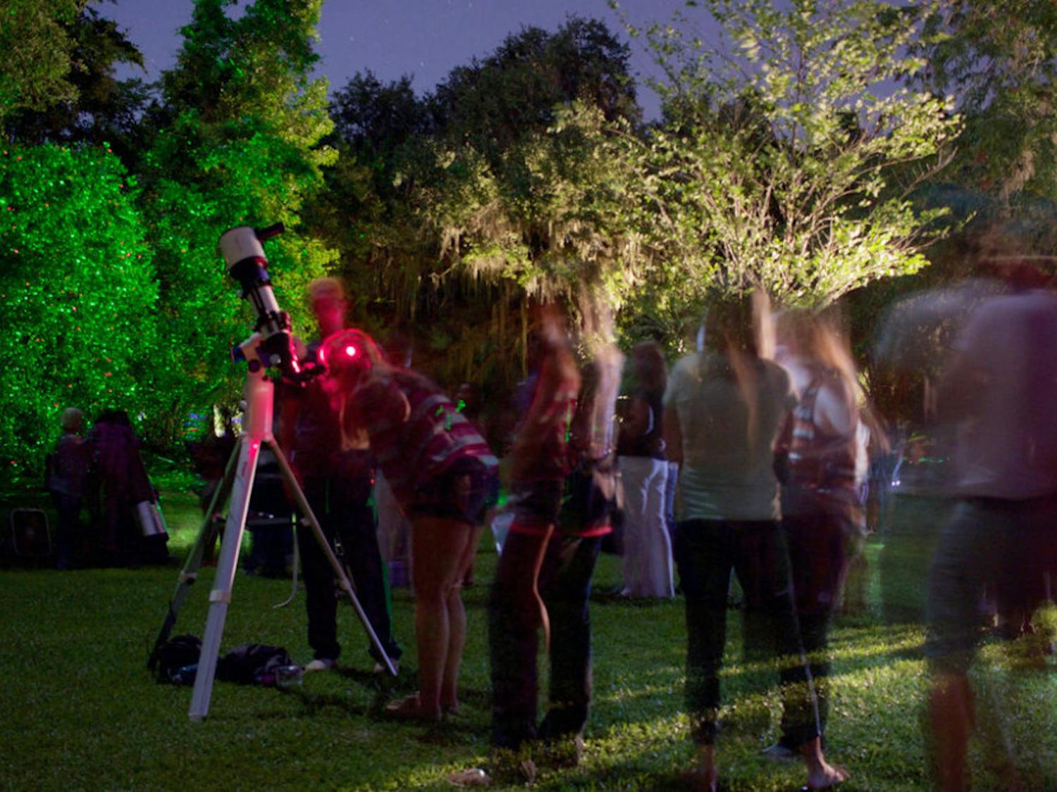 Visitors to Kanapaha Botanical Gardens stand in line to view the moon hundreds of times closer during the annual Moonlight Walk.