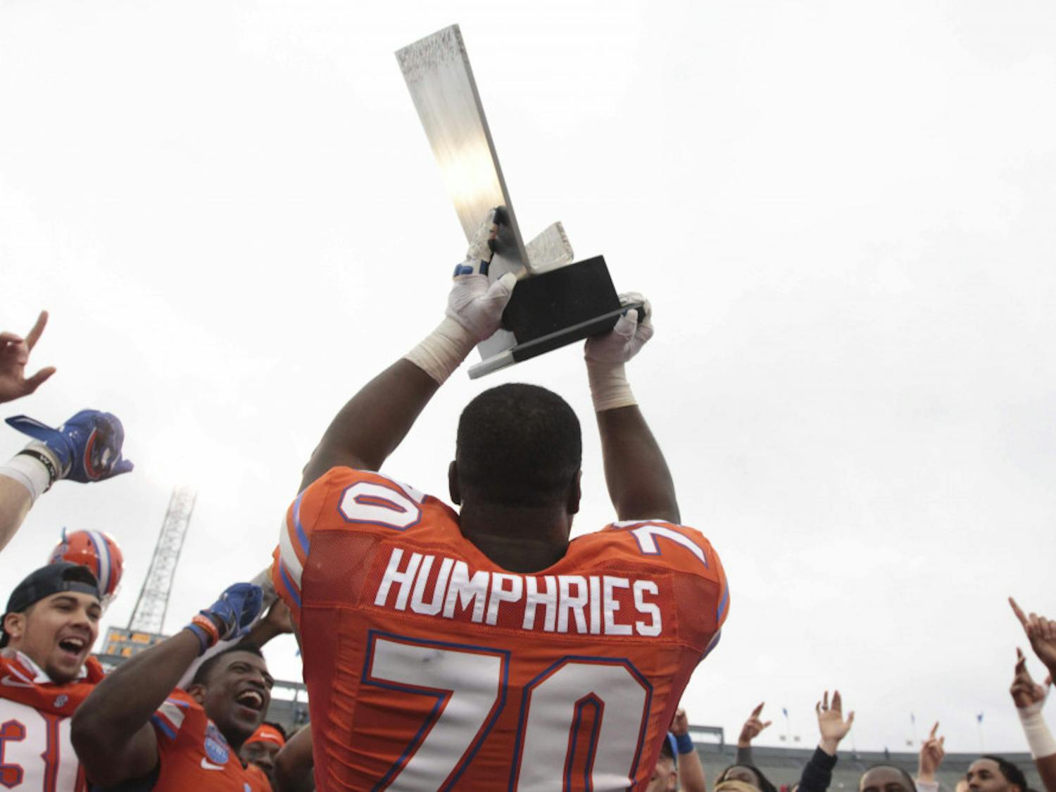 D.J. Humphries holds up the Birmingham Bowl trophy following Florida's 28-20 win against East Carolina on Saturday at Legion Field.