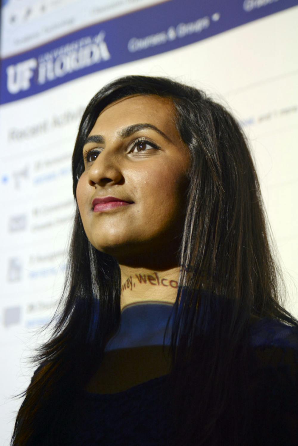 <p>Stela Patidar, a 20-year-old UF psychology sophomore enrolled in the Innovation Academy, poses for a photo in Turlington Hall against a projection of her Canvas dashboard. A student on the pre-med track, Patidar is concerned about keeping up with her classes and studying for the MCAT while on the Spring-Summer calendar.</p>