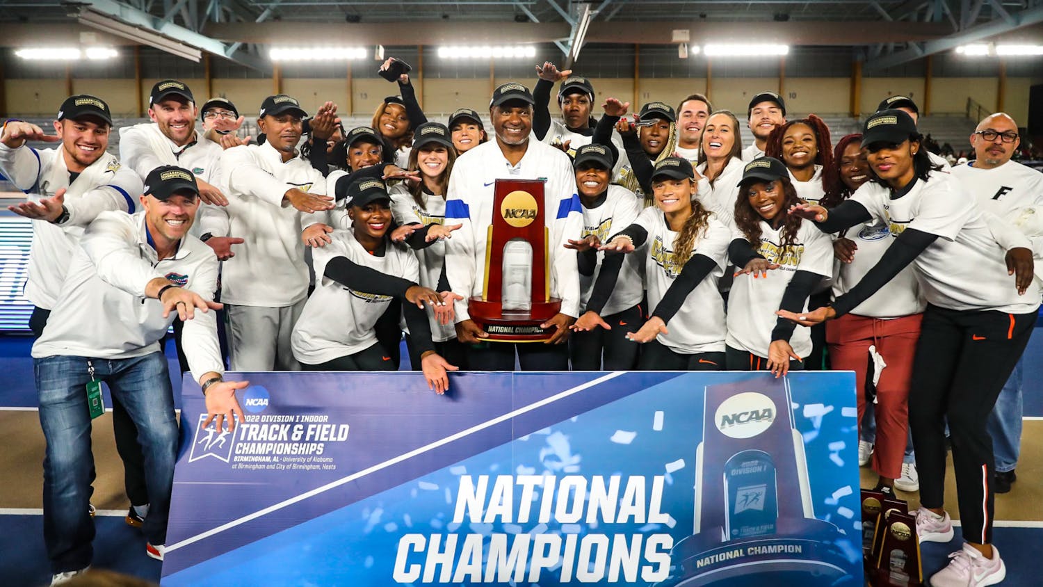Florida women’s track team and head coach Mike Holloway raise the NCAA Indoor Championship trophy