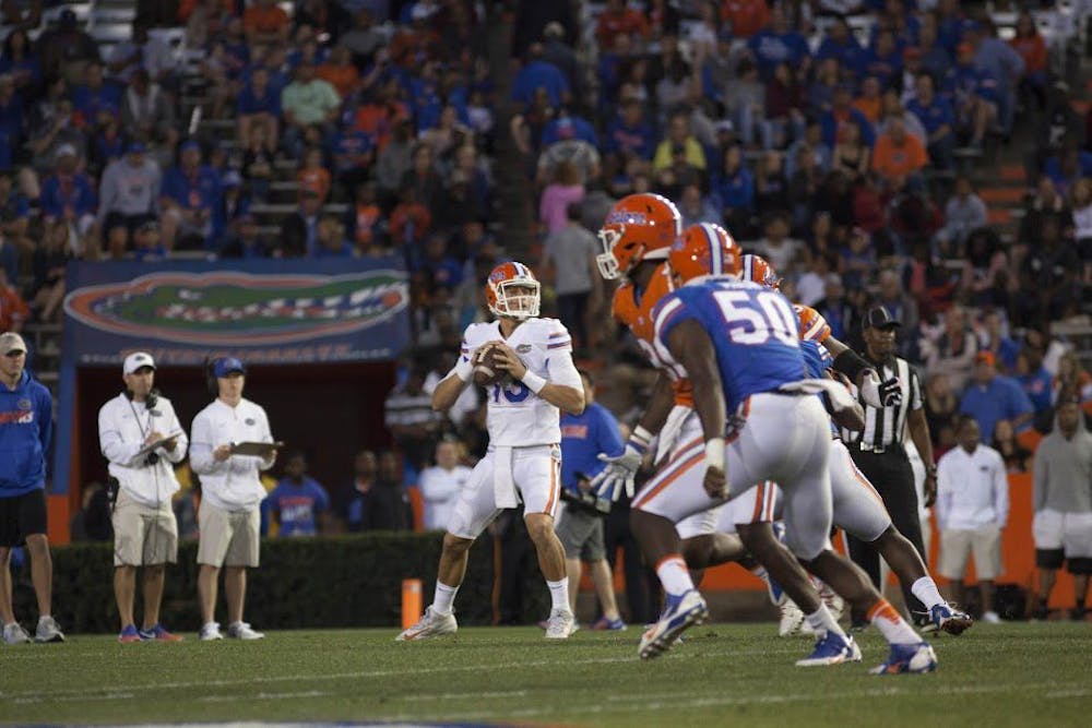 <p>UF quarterback Feleipe Franks drops back to pass during Florida's Spring game on Friday night at Ben Hill Griffin Stadium.</p>