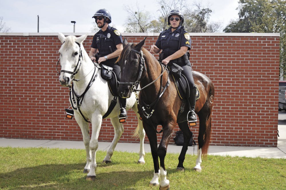 From left: Officer Ryan Foster rides Merlin and Cpl. Tracy Fundenburg rides Zeus. The two horses have been working for Gainesville Police’s mounted unit for about 10 years. On Tuesday, the horses retired.
&nbsp;