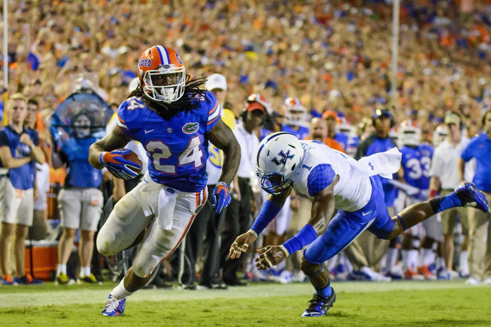 <p>UF running back Matt Jones carries the ball during Florida's 36-30 triple-overtime win against Kentucky on Saturday at Ben Hill Griffin Stadium.</p>