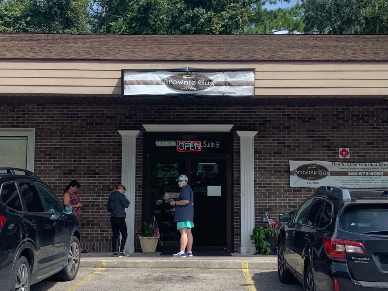 Customers wait outside Brownie Guy on its final day Monday Sept. 12. 