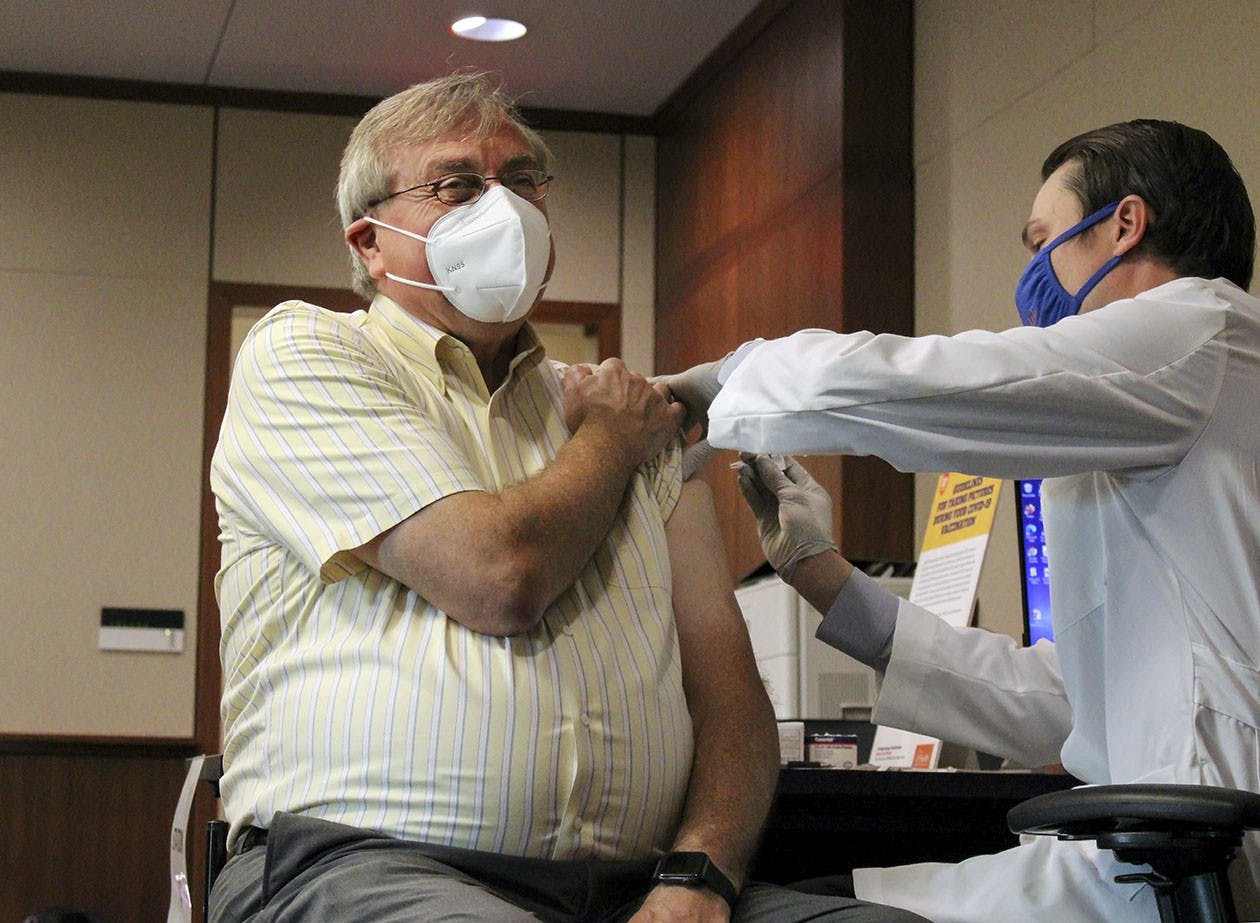 UF President Kent Fuchs receives his first dose of the Pfizer COVID-19 vaccine at UF Health Shands Cancer Hospital Tuesday, Jan. 5, 2021. UF professors are still waiting for their vaccines after Gov. Ron Desantis excluded higher education faculty when access to vaccines was expanded to other groups, including K-12 teachers over 50, on Wednesday, March 3, 2021.