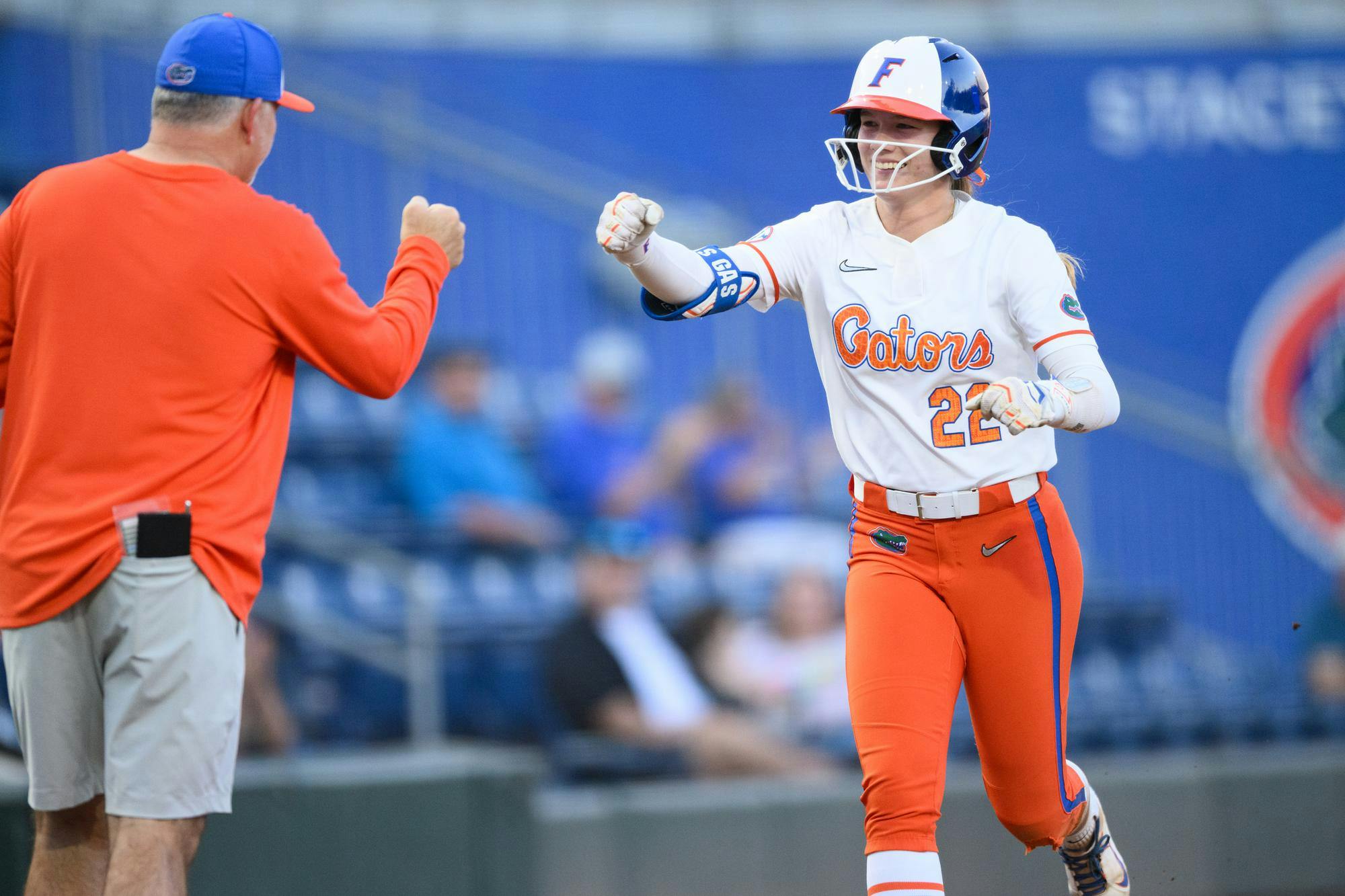 Florida outfielder Cassidy McLellan (22) fist bumps head coach Tim Walton after hitting a home run during an NCAA softball game against FGCU, Wednesday, April 15, 2026, in Gainesville, Fla.