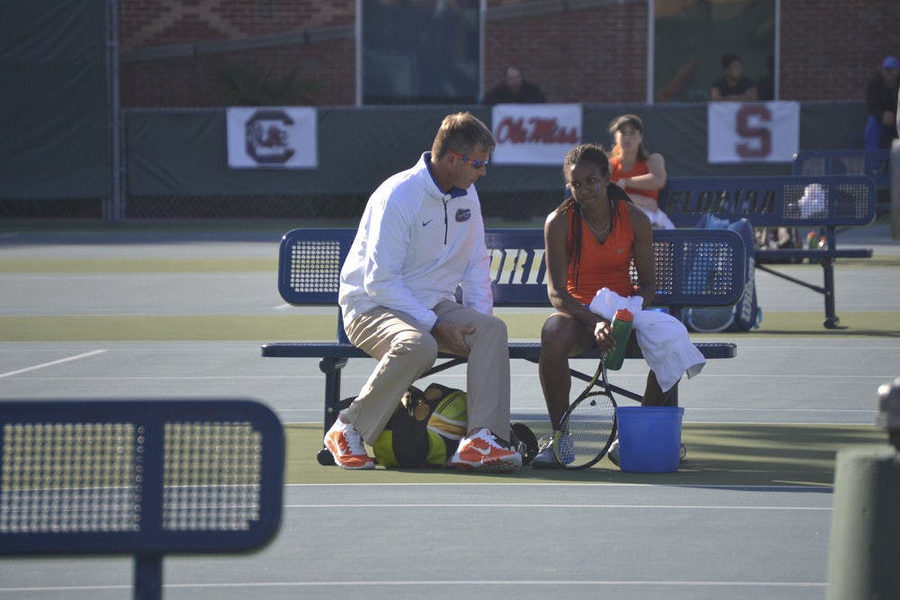 UF coach Roland Thornqvist talks with Brianna Morgan during Florida's 4-0 win against Maryland on Jan. 25, 2015, at the Ring Tennis Complex.