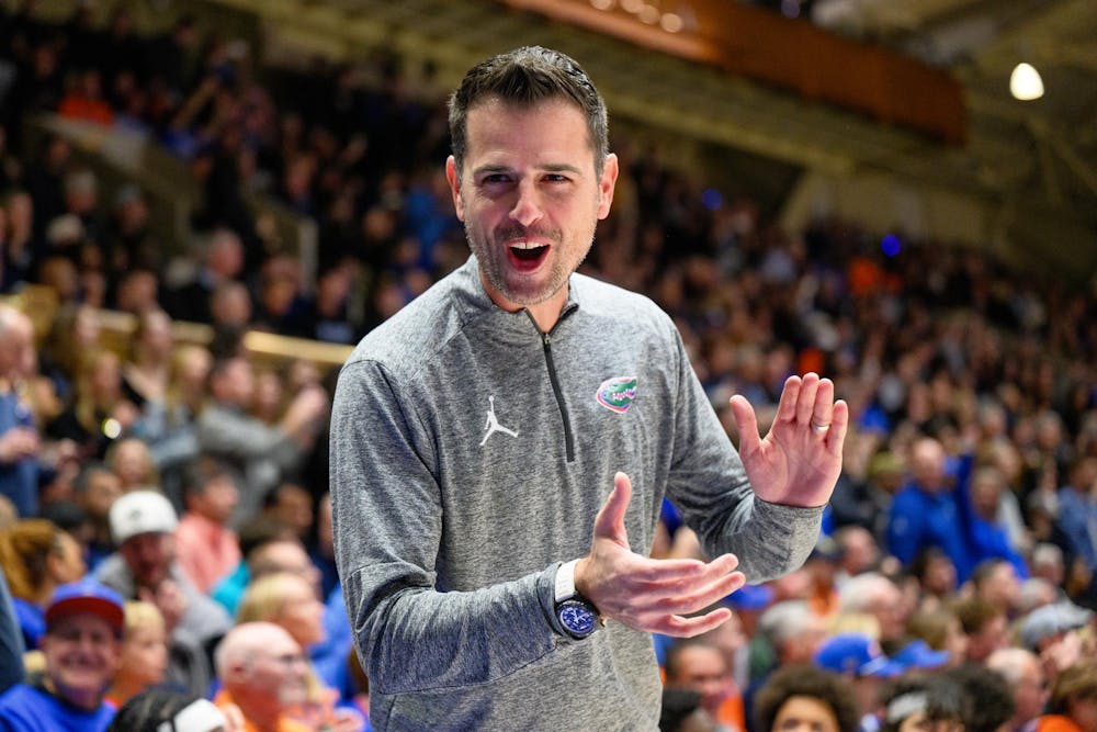 Florida head coach Todd Golden claps and smiles before an NCAA college basketball game against Duke, Tuesday, Dec. 2, 2025, at Cameron Indoor Stadium in Durham, NC.