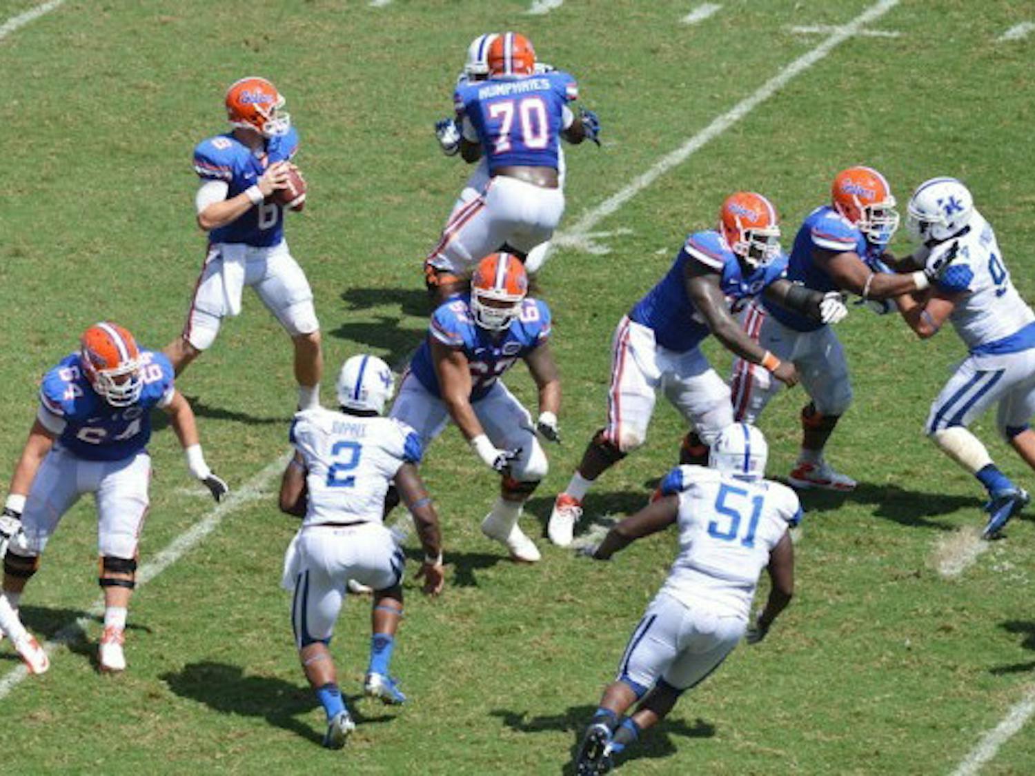 Sophomore quarterback Jeff Driskel (6) drops back to pass as his offensive line withstands the rush against the Kentucky Wildcats on Saturday at Ben Hill Griffin Stadium. Despite injuries, the Florida offensive line has progressed in pass and run blocking since playing Texas A&amp;M in the conference opener on Sept. 8.