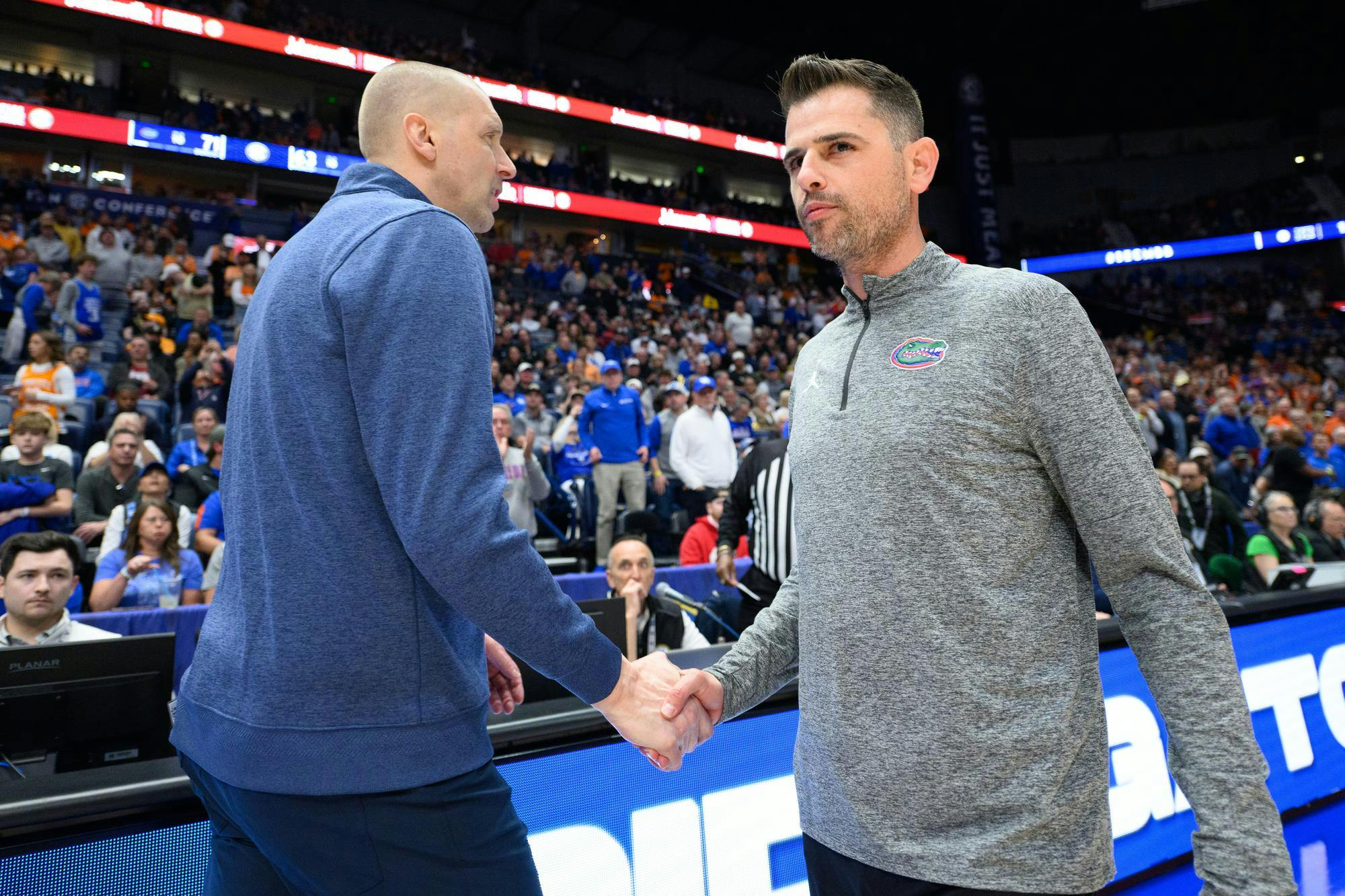 Florida head coach Todd Golden shakes hands with Kentucky head coach Mark Pope after an SEC Men's Basketball Tournament quarterfinal game, Friday, March 13, 2026, in Nashville, Tenn.
