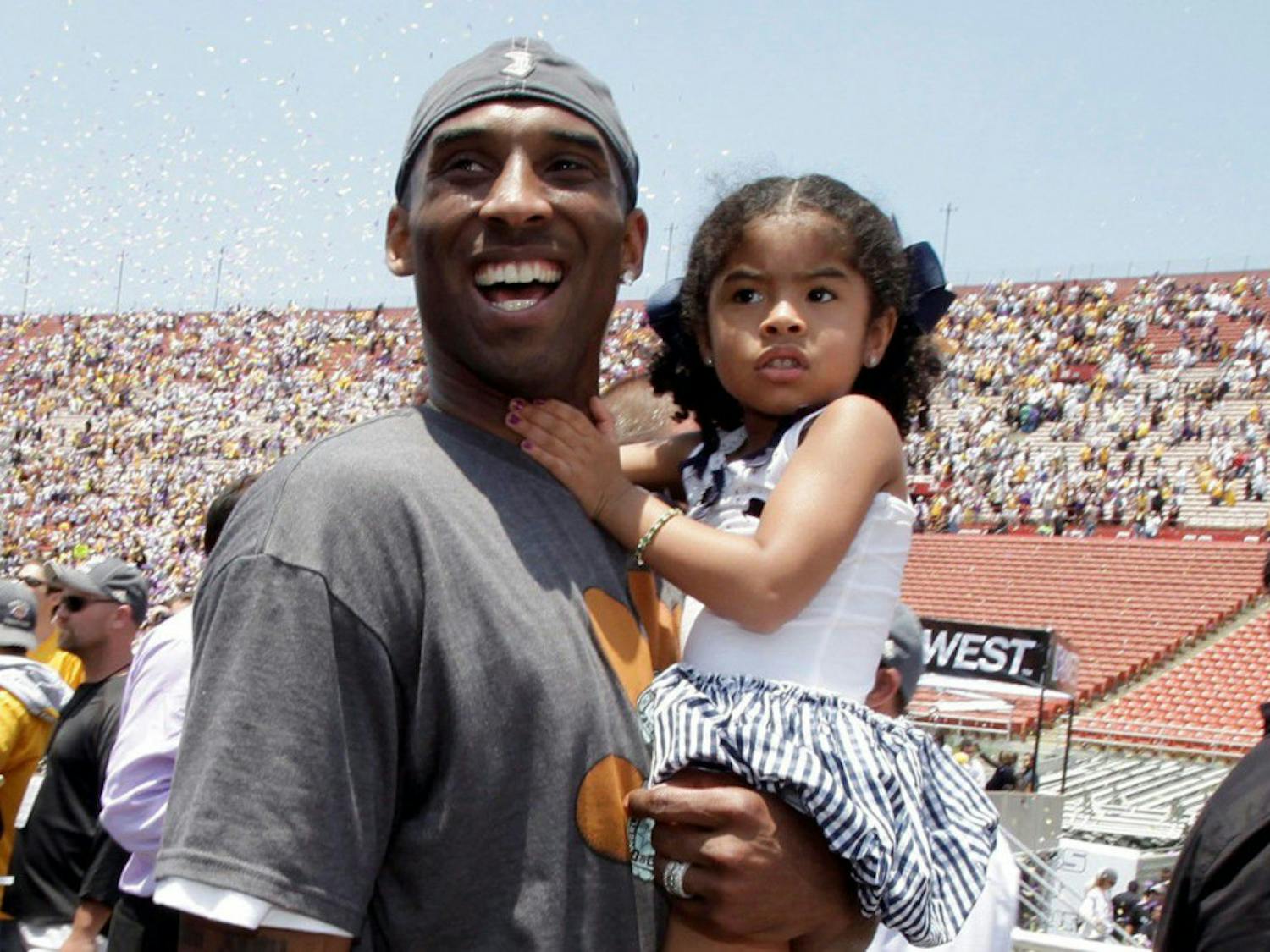 In this June 17, 2009 file photo Los Angeles Lakers' Kobe Bryant smiles as he and his daughter Gianna Maria-Onore walk up the steps after the victory parade celebrating the Lakers' NBA championship in Los Angeles. Bryant, the 18-time NBA All-Star who won five championships and became one of the greatest basketball players of his generation during a 20-year career with the Los Angeles Lakers, died in a helicopter crash Sunday, Jan. 26, 2020. Gianna also died in the crash. (AP Photo/Jae C. Hong, file)