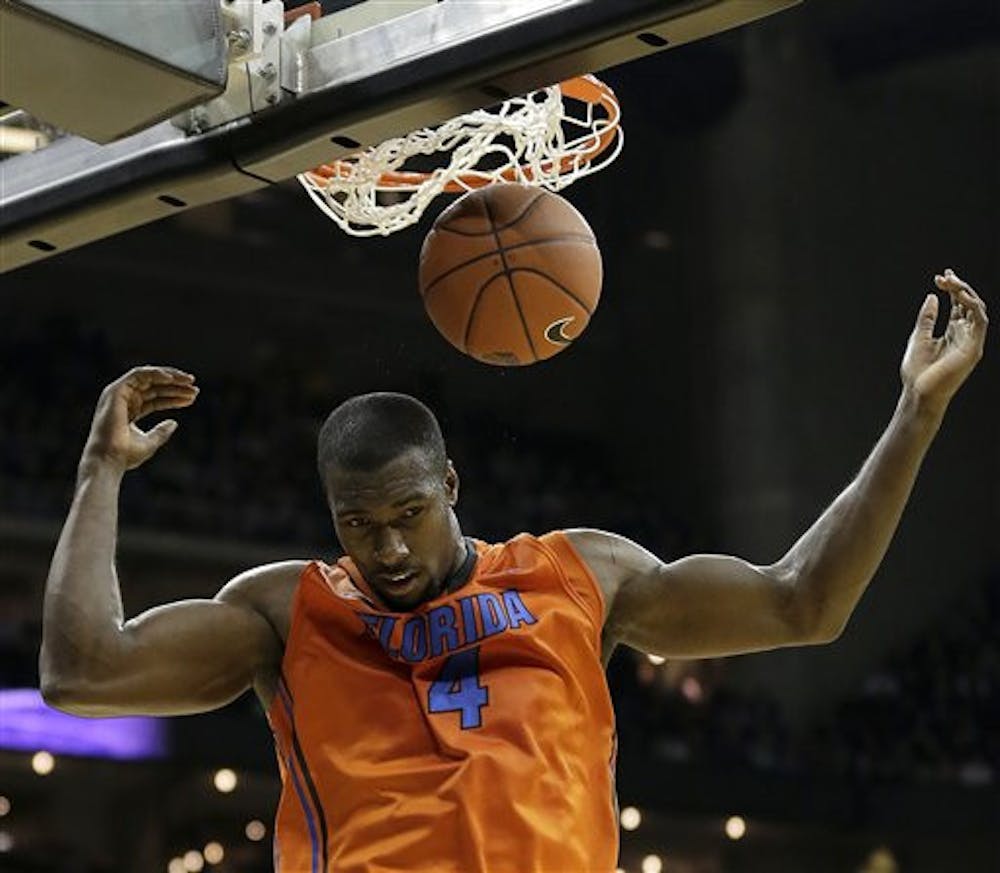 <p>Florida center Patric Young (4) dunks the ball during the second half against Kansas State on Saturday at the Sprint Center in Kansas City, Mo. Kansas State won the game 67-61.&nbsp;</p>