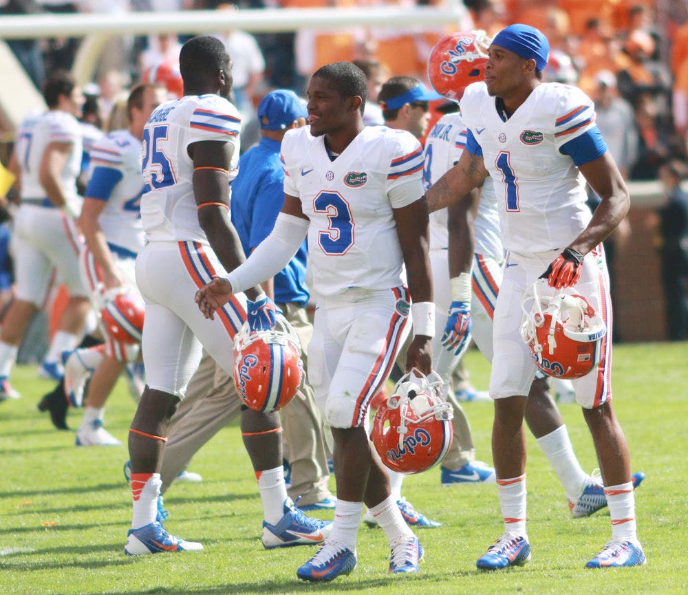 UF quarterback Treon Harris (3) walks off the field of Neyland Stadium with wide receiver Quinton Dunbar (1) following Florida's 10-9 win against Tennessee on Saturday in Knoxville, Tenn.