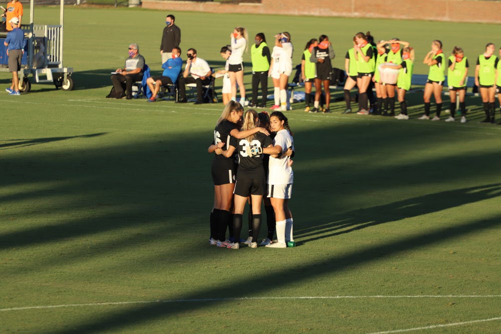 Gators stand in a huddle in their final home game of the 2020 season. Florida will play two road games this weekend against SEC opponents Kentucky and Missouri.