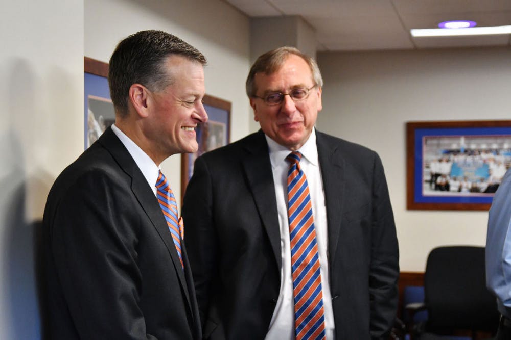 <p>UF athletic director Scott Stricklin talks with president Kent Fuchs during Florida's search committee meeting on Sept. 27, 2016, at the Kelly Smith Conference Room.</p>
